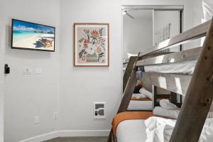 a bedroom with two bunk beds and a mirror at Stunning Oceanfront Boardwalk Condo - Spa, Steps2Beach, Parking & Fast Wifi! in San Diego