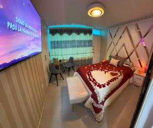 a bedroom with a bed and a projection screen at Gold House Oro in Quito
