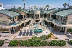 an aerial view of a resort with a swimming pool at Stunning Oceanfront Boardwalk Condo - Spa, Steps2Beach, Parking & Fast Wifi! in San Diego
