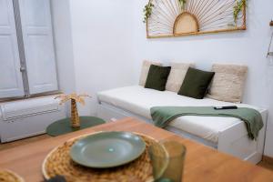 a living room with a couch and a table at Le Verger des Papes in Avignon
