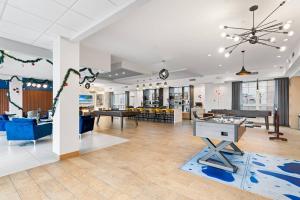 a large room with tables and chairs in a building at Supreme 2 Bedroom Condo in Prime Jersey City in Jersey City