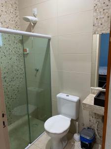 a bathroom with a toilet and a glass shower at Casa Cactos in Piranhas +7 photos