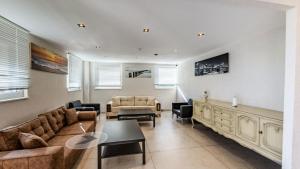 a living room with a couch and a table at DiDo Diamond Hotel in Dietzenbach