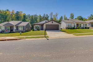 a house on a street with a driveway at 13 Mi to Tuscaloosa Riverwalk Cottondale Home in Cottondale