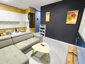 a living room with a couch and a table at Deas Apartments in Tirana in Tirana +19 photos