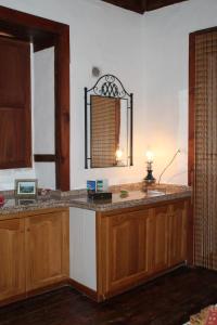 a kitchen with a counter with a mirror and a sink at Casas Rurales Los Marantes in Puntagorda +101 photos
