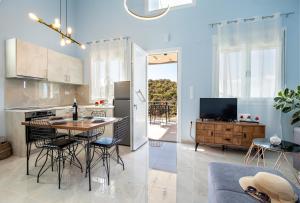 a kitchen and living room with a table and chairs at ADK Maison in Skala Marion
