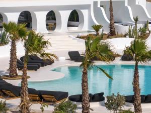 a resort with palm trees and a swimming pool at Million Stars Mykonos, Iconic by Design in Mikonos