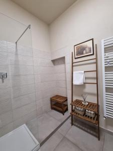 a bathroom with a shower with a glass shower stall at 35 Rooms Palazzo Buoninsegni in Colle Val D'Elsa +28 photos