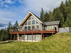 a house on top of a grassy hill at Leavenworth Mountain View Alpine Escape in Leavenworth