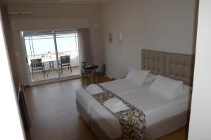Ένα ή περισσότερα κρεβάτια σε δωμάτιο στο CHIOS HOTEL