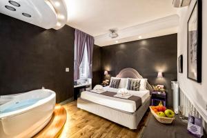 a bedroom with a bed and a bath tub and a bed and a bathroom at Magenta Collection Sant'Anna in Rome