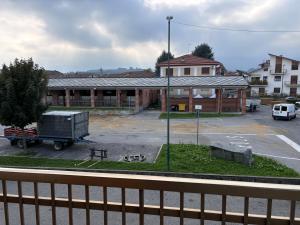 a building with a truck in front of a parking lot at Pink appartament in Bagnolo Piemonte