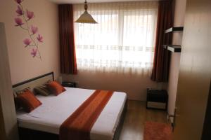 A bed or beds in a room at Family Hotel Lebed