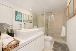 a white bathroom with a sink and a toilet at New Condo With 2BR in San Lucas in Cabo San Lucas +21 photos