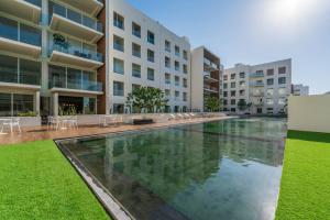 a large swimming pool in front of a building at New Condo With 2BR in San Lucas in Cabo San Lucas