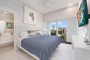 a bedroom with a large bed and a bathroom at New Condo With 2BR in San Lucas in Cabo San Lucas