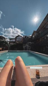 a person laying on the edge of a swimming pool at Refúgio Muas Nature in Vila Real