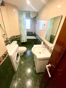 a bathroom with a toilet and a sink and a toilet istg at City center 34 in Podgorica +15 photos