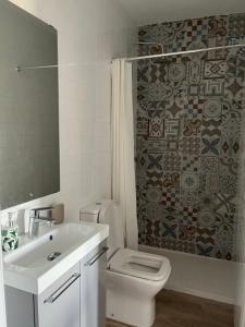 a bathroom with a sink and a toilet and a shower at Santo Domingo Rural - central & private parking in Archidona