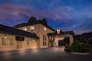 a hotel with a sign on the front of it at Best Western Plus Osoyoos Hotel & Suites in Osoyoos