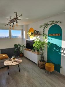 a living room with a table and some plants at El Mirador del Pilar - Parking y vistas a la basílica in Zaragoza