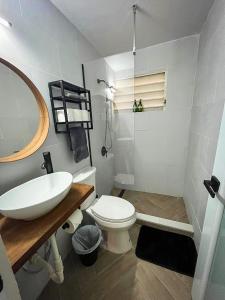 a white bathroom with a sink and a toilet at Relaxing Retreat for 5 Close to Beach & Airport in Carolina