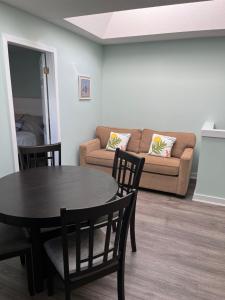 a living room with a table and a couch at Aloha Cottage, Nanoose Bay - 2 Bdrm Oceanfront Unit with Private Deck in Nanoose Bay