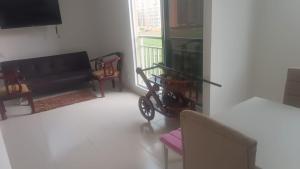 a living room with a black couch and a balcony at apartamento Amazilia en alameda del rio in Barranquilla