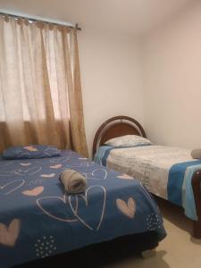 a bedroom with two beds with hearts on them at apartamento Amazilia en alameda del rio in Barranquilla