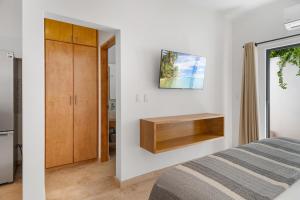 a bedroom with a bed and a cabinet at Pineda Suite #102 two blocks from the Malecon in La Paz