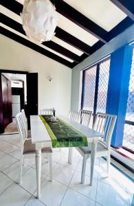 a dining room with a white table and chairs at 28 OFF Affordable Beautiful Queen Bedroom Near City Swan River Fremantle University in Perth