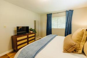 a bedroom with a bed and a tv on a dresser at Centrally Located 2 King Bed Midtown Memphis 2362 in Memphis