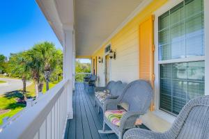 a porch with two wicker chairs and a window at 1 Mi to Beach and Hot Tub Murrells Inlet Retreat! in Myrtle Beach