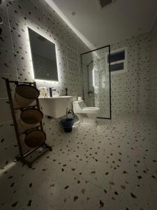 Un baño con inodoro, lavabo y espejo. en استديو فندقي - مودرن فاخر كبير جدا, en Riad
