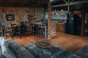 a kitchen and living room with a couch and a table at Refugio Santa Elena in Santa Elena