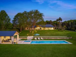 a backyard with a pool and a house at Fairway at Federal in Federal