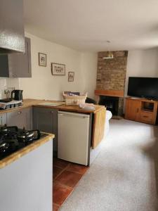 a kitchen with a sink and a stove top oven at Historic peaceful cottage in town centre! in Barnard Castle