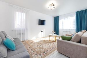 TaldykolʼにあるSezim Qala 10のリビングルーム(グレーのソファ、青い枕付)