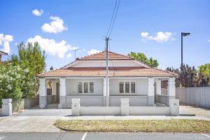 a white house with a red roof at Chic Semi-Detached 2-Bed Home with Outdoor Dining in Perth