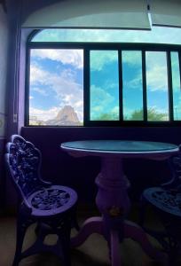 a table and two chairs in a room with a window at Casa Morada in Bernal