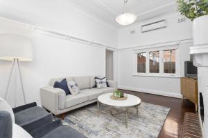 a living room with a couch and a table at Elegant Art Deco Semi Detached 2-Bed Home by Parks in Perth