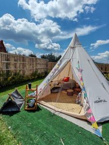 a white tent with a bed in a yard at El Mirador Family Glamping INDIA AMERICANA in Estancia de Itargua