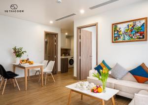 a living room with a couch and a table at SQ Thao Dien in Ho Chi Minh City