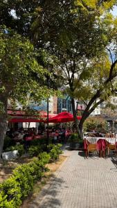 a patio with tables and chairs in a park with trees at MC Apartments Recoleta - Guido in Buenos Aires