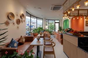 a restaurant with a row of tables and chairs at Tropical Paradise Sapa Hotel & Tour in Sapa