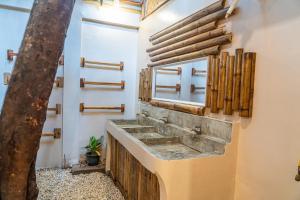 a bathroom with a stone sink on the wall at CocoRico Hostel in San Vicente +37 photos
