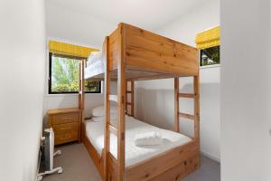 a bedroom with two bunk beds and a desk at Lodges 6 - Lake views and close to town in Queenstown