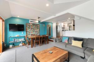 a living room with a couch and a table at Lodges 6 - Lake views and close to town in Queenstown