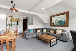 a living room with a couch and a table at Lodges 6 - Lake views and close to town in Queenstown
